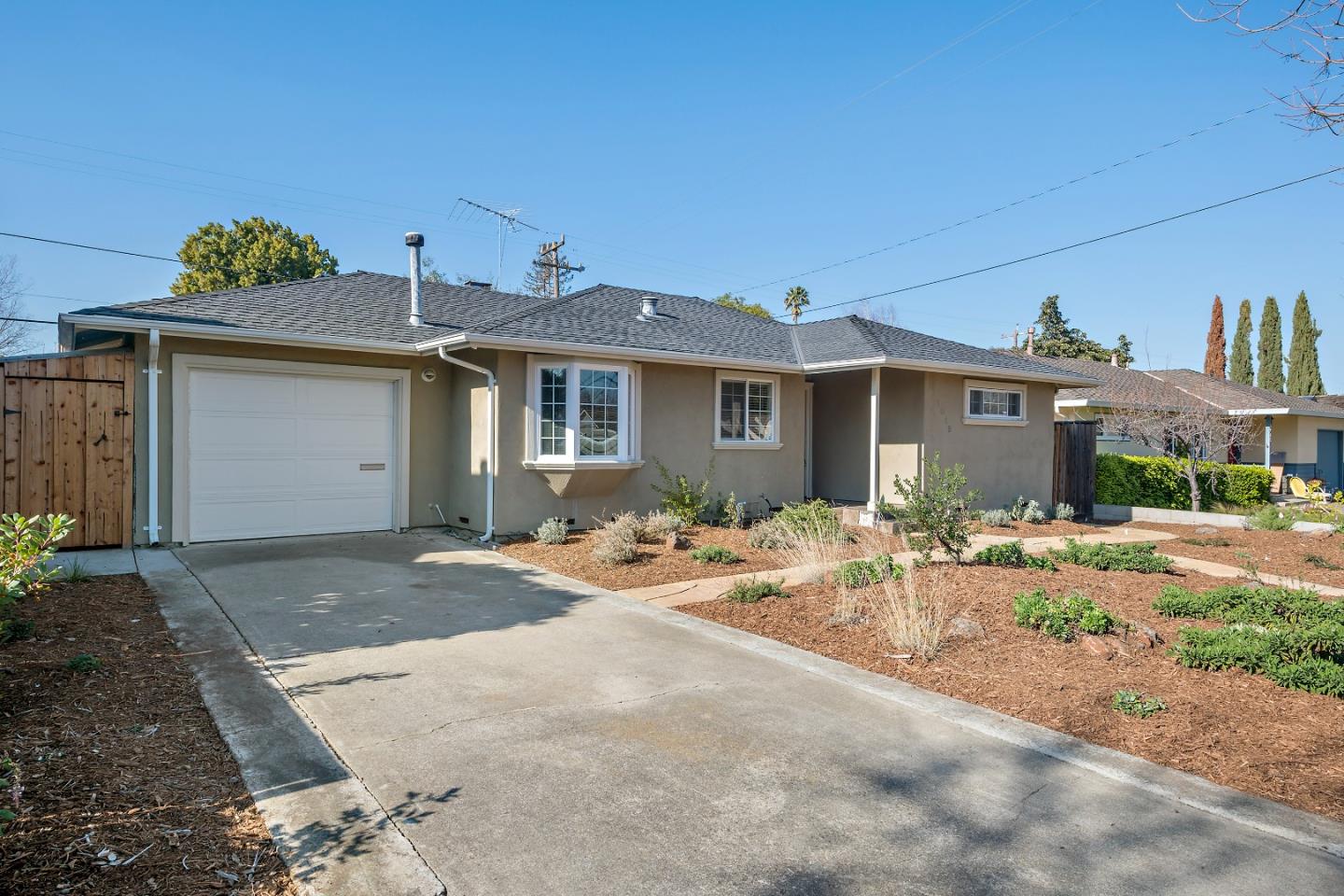 1019 Mango Avenue Sunnyvale, CA 94087 - Photo 2 of 17 a front view of a house with yard and garage