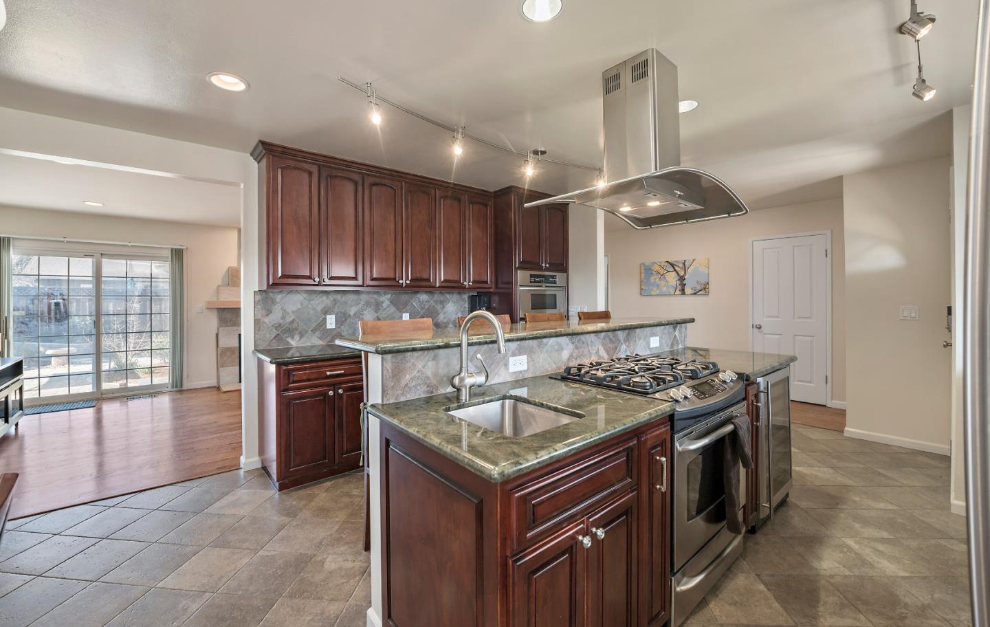 1019 Mango Avenue Sunnyvale, CA 94087 - Photo 7 of 17 a kitchen with a stove sink and a refrigerator