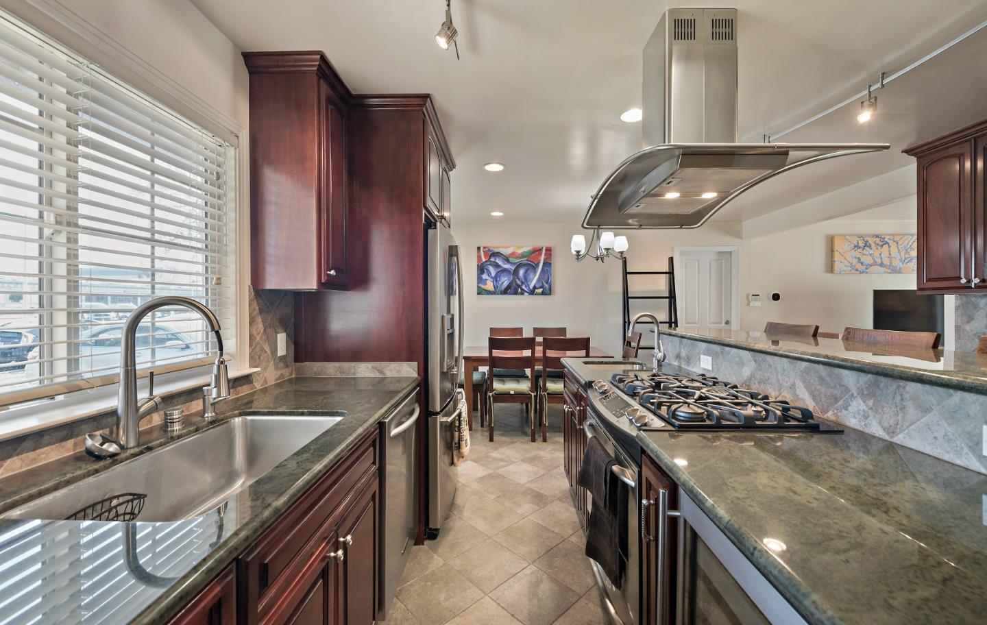 1019 Mango Avenue Sunnyvale, CA 94087 - Photo 8 of 17 a kitchen with stainless steel appliances granite countertop a sink stove and cabinets