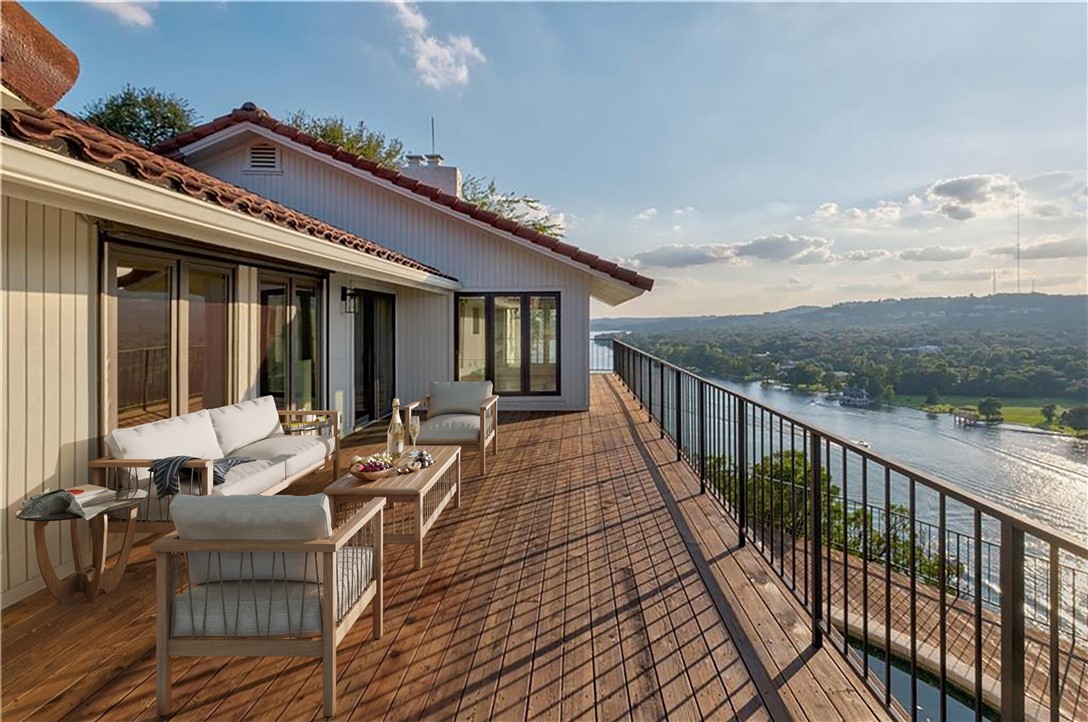 a balcony with furniture and a potted plant
