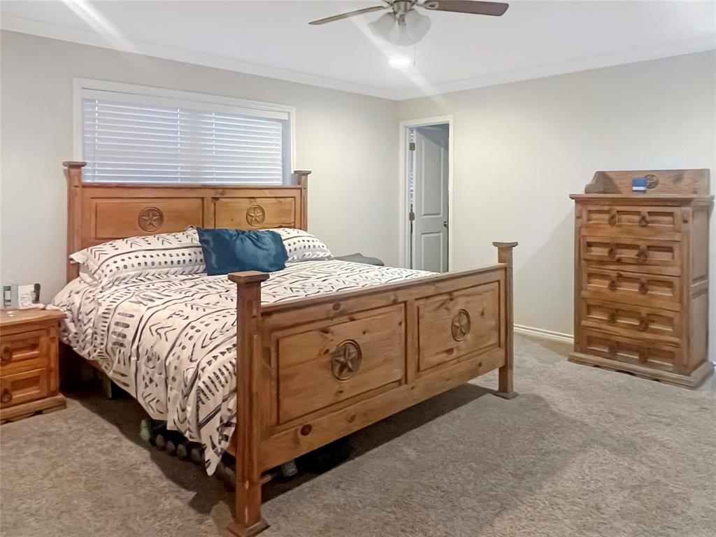 584 Highway 16 Graham, TX 76450 - Photo 12 of 22 a bedroom with a bed and a dresser