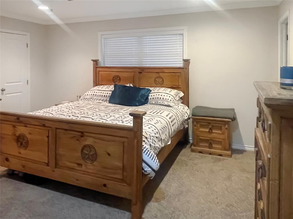 584 Highway 16 Graham, TX 76450 - Photo 13 of 22 a bedroom with a bed and a dresser