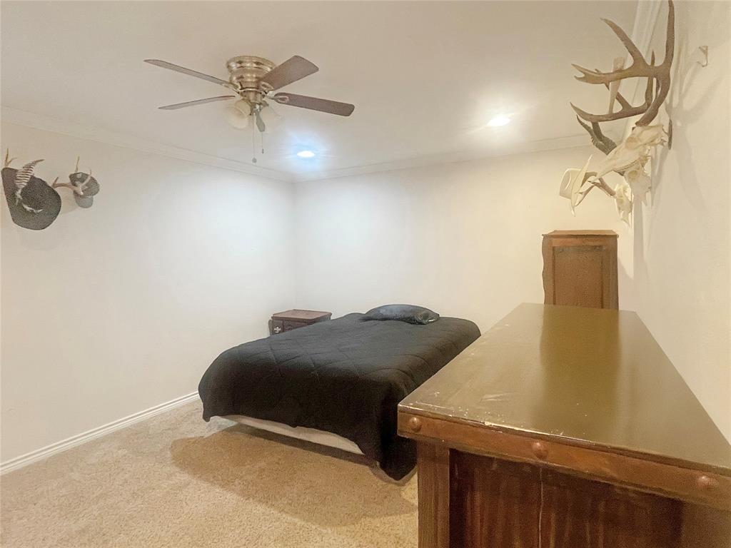 584 Highway 16 Graham, TX 76450 - Photo 17 of 22 a bedroom with a bed and a table