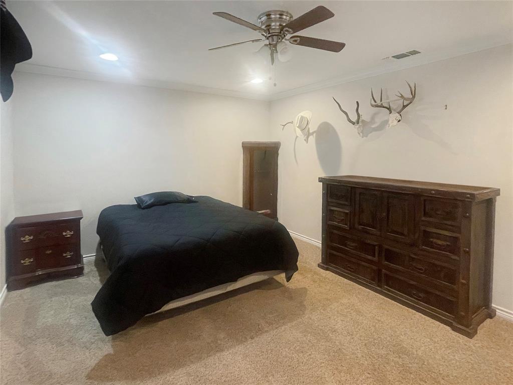 584 Highway 16 Graham, TX 76450 - Photo 18 of 22 a bedroom with a bed and a dresser