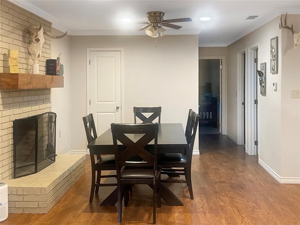 584 Highway 16 Graham, TX 76450 - Photo 9 of 22 a view of a dining room with furniture and a fireplace