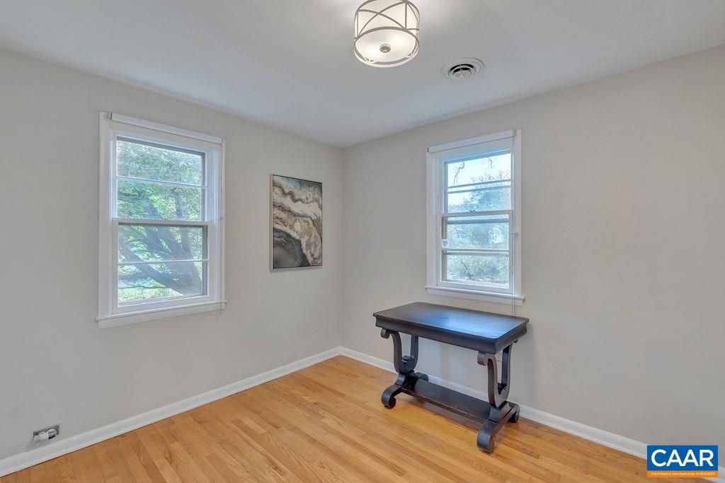 301 Georgetown Lane Charlottesville, VA 22901 - Photo 12 of 39 a view of a workspace with a window and a gym cycle