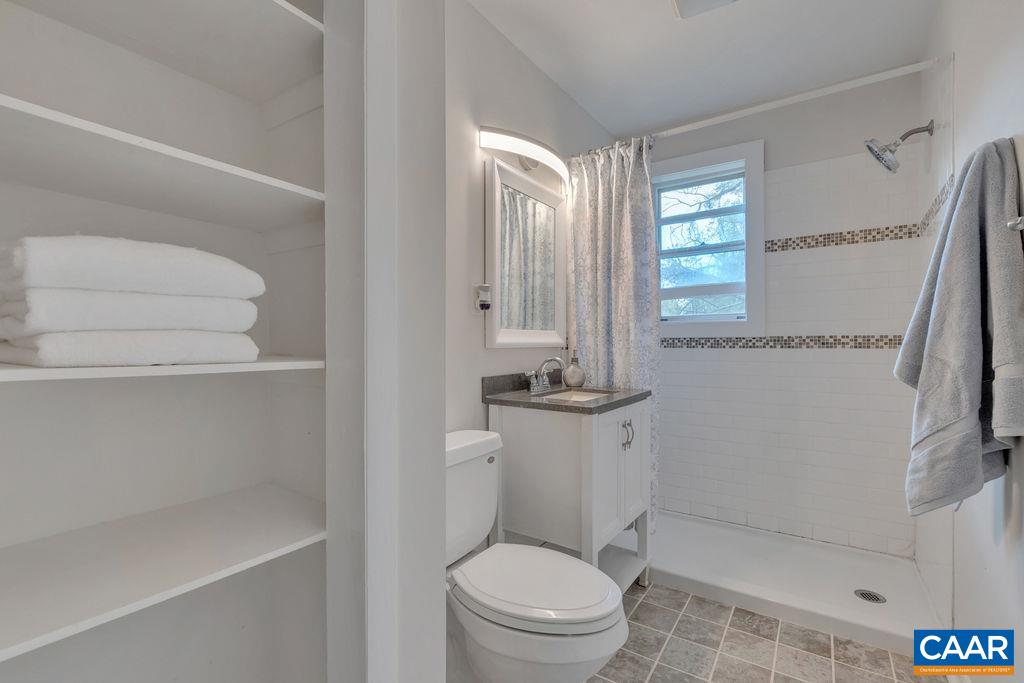 301 Georgetown Lane Charlottesville, VA 22901 - Photo 13 of 39 a bathroom with a granite countertop sink a toilet and shower