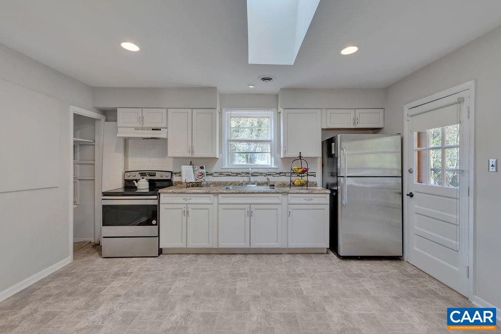 301 Georgetown Lane Charlottesville, VA 22901 - Photo 7 of 39 a kitchen with a refrigerator and a stove top oven