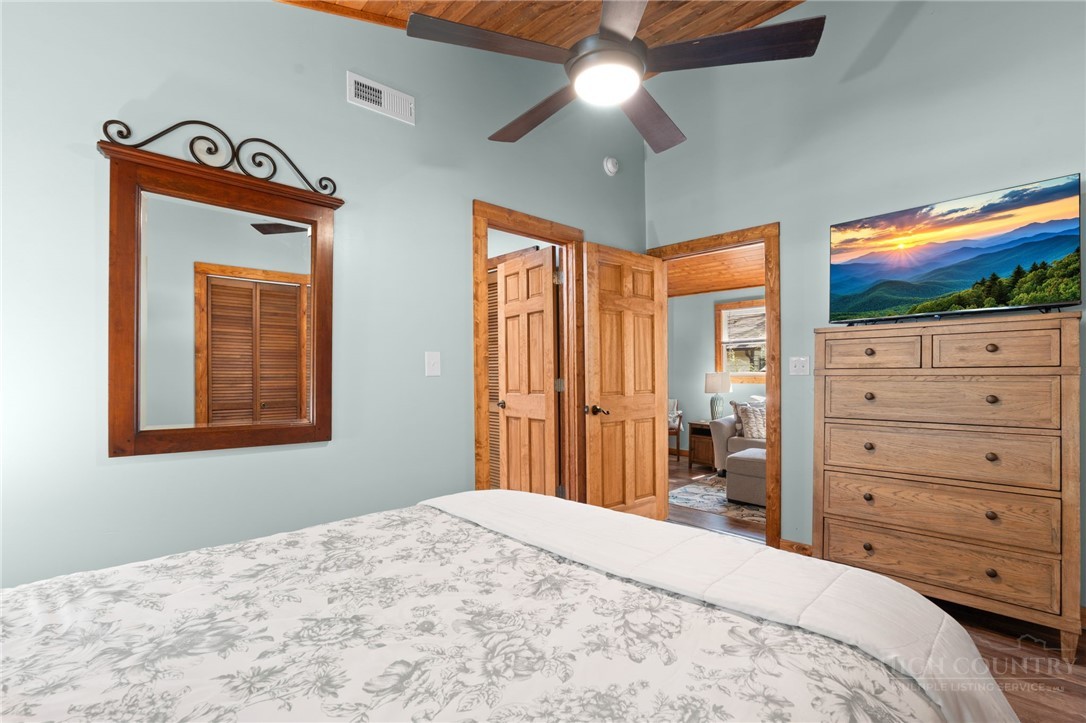 139 Golden Rod Loop Newland, NC 28657 - Photo 17 of 39 a bedroom with a bed and a chandelier