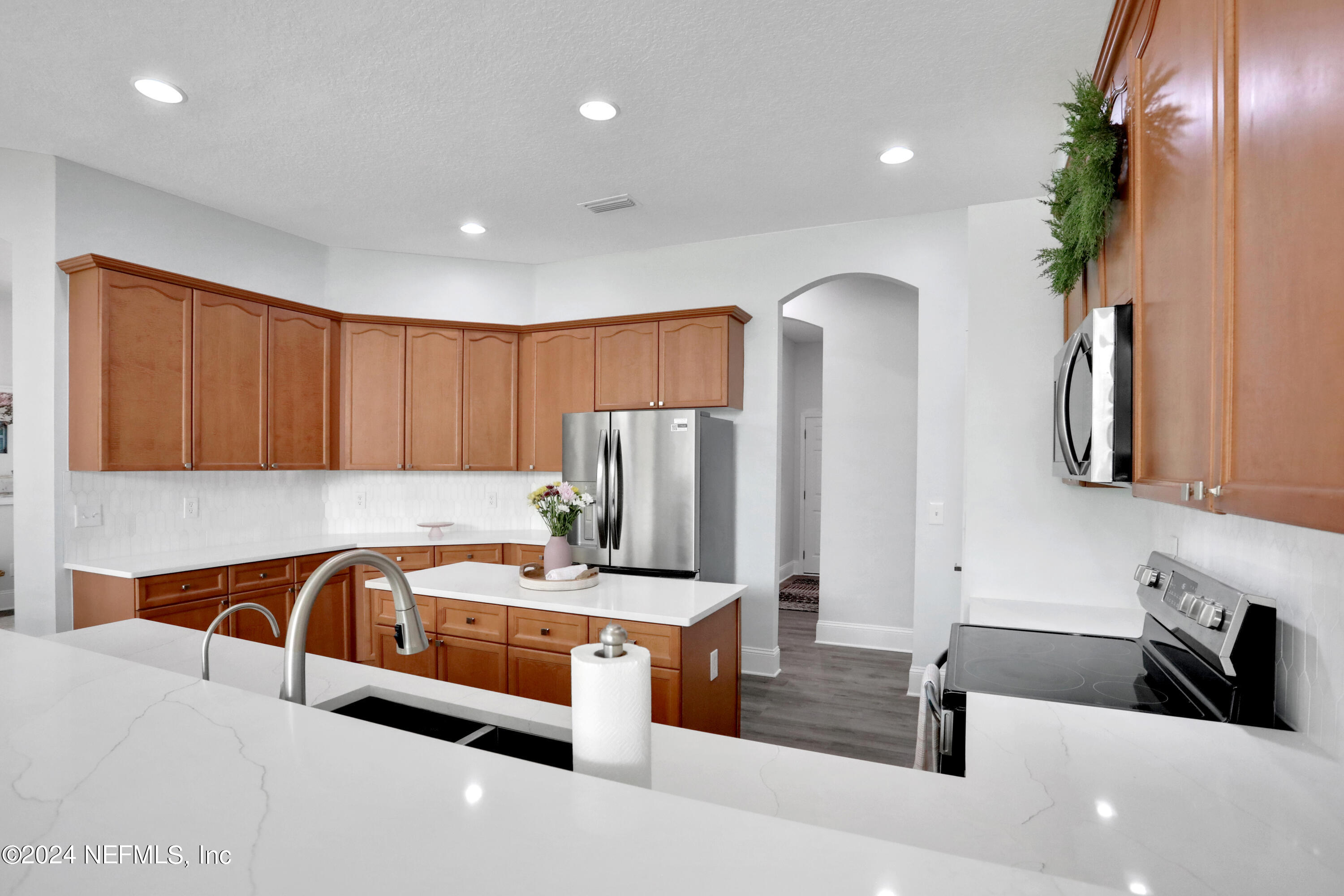 346 Porta Rosa Circle St. Augustine, FL 32092 - Photo 24 of 53 a kitchen with stainless steel appliances granite countertop a sink and a refrigerator