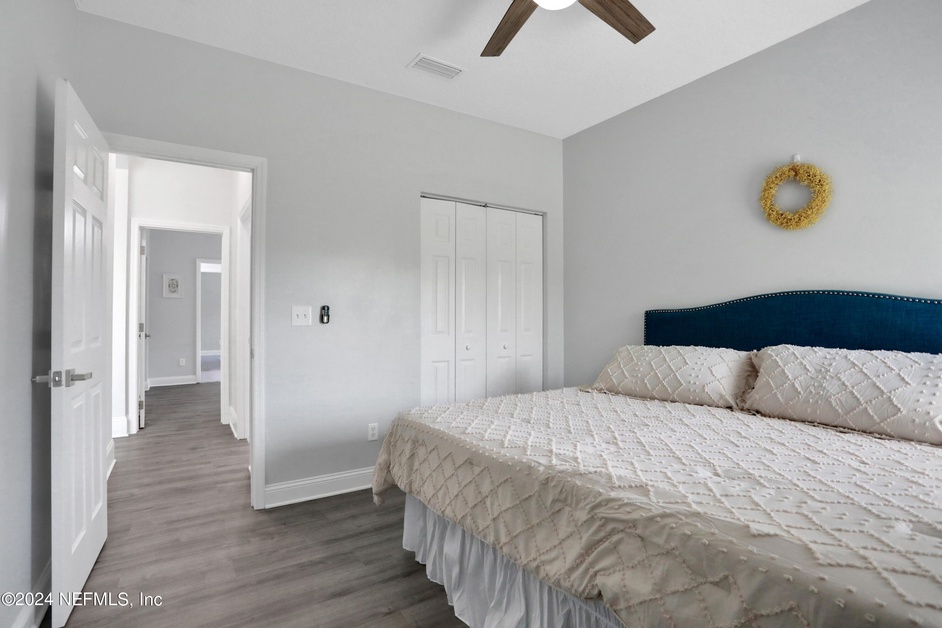 346 Porta Rosa Circle St. Augustine, FL 32092 - Photo 29 of 53 a bedroom with a bed and a chandelier