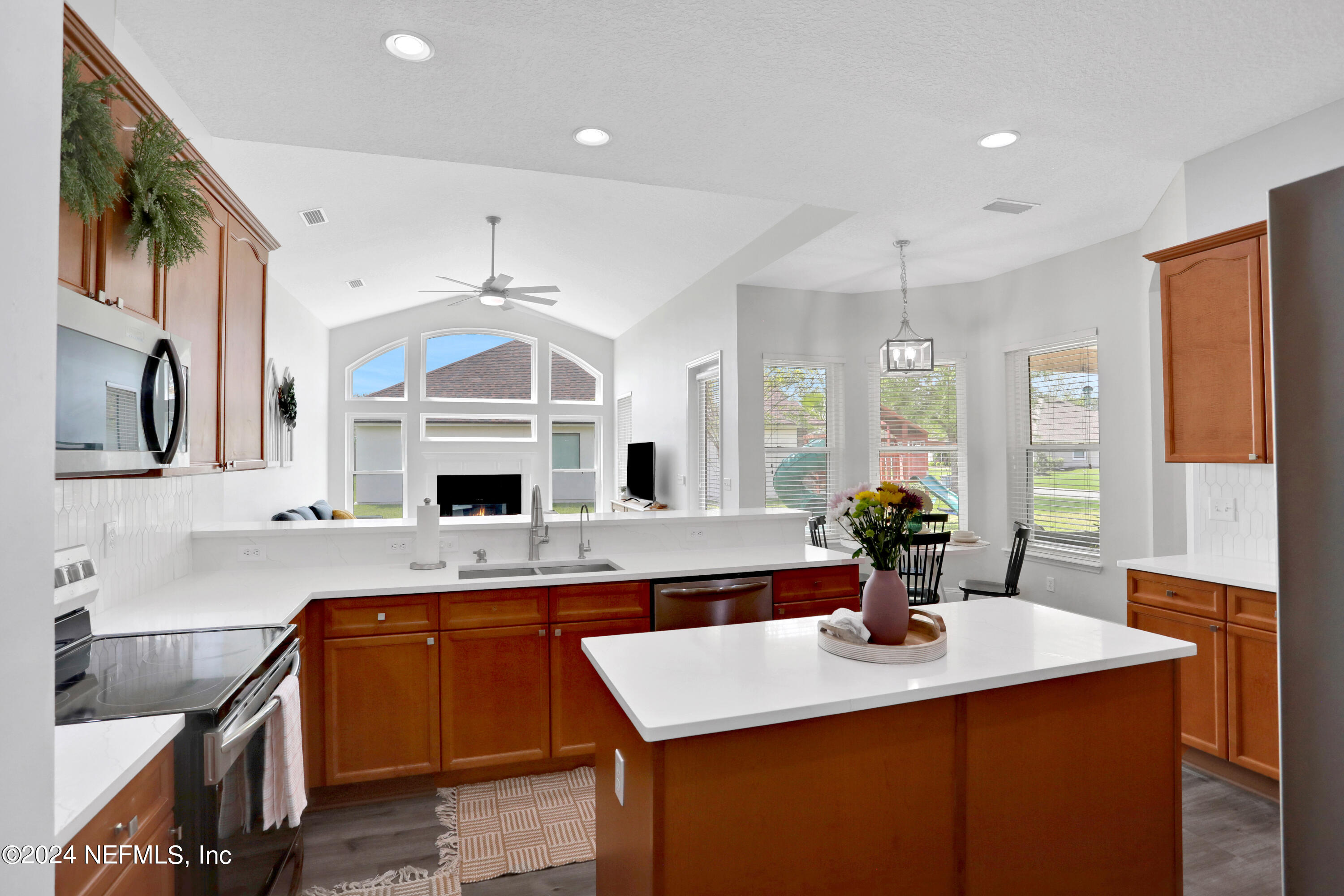 346 Porta Rosa Circle St. Augustine, FL 32092 - Photo 3 of 53 a kitchen with a sink dishwasher a stove and a refrigerator with wooden floor