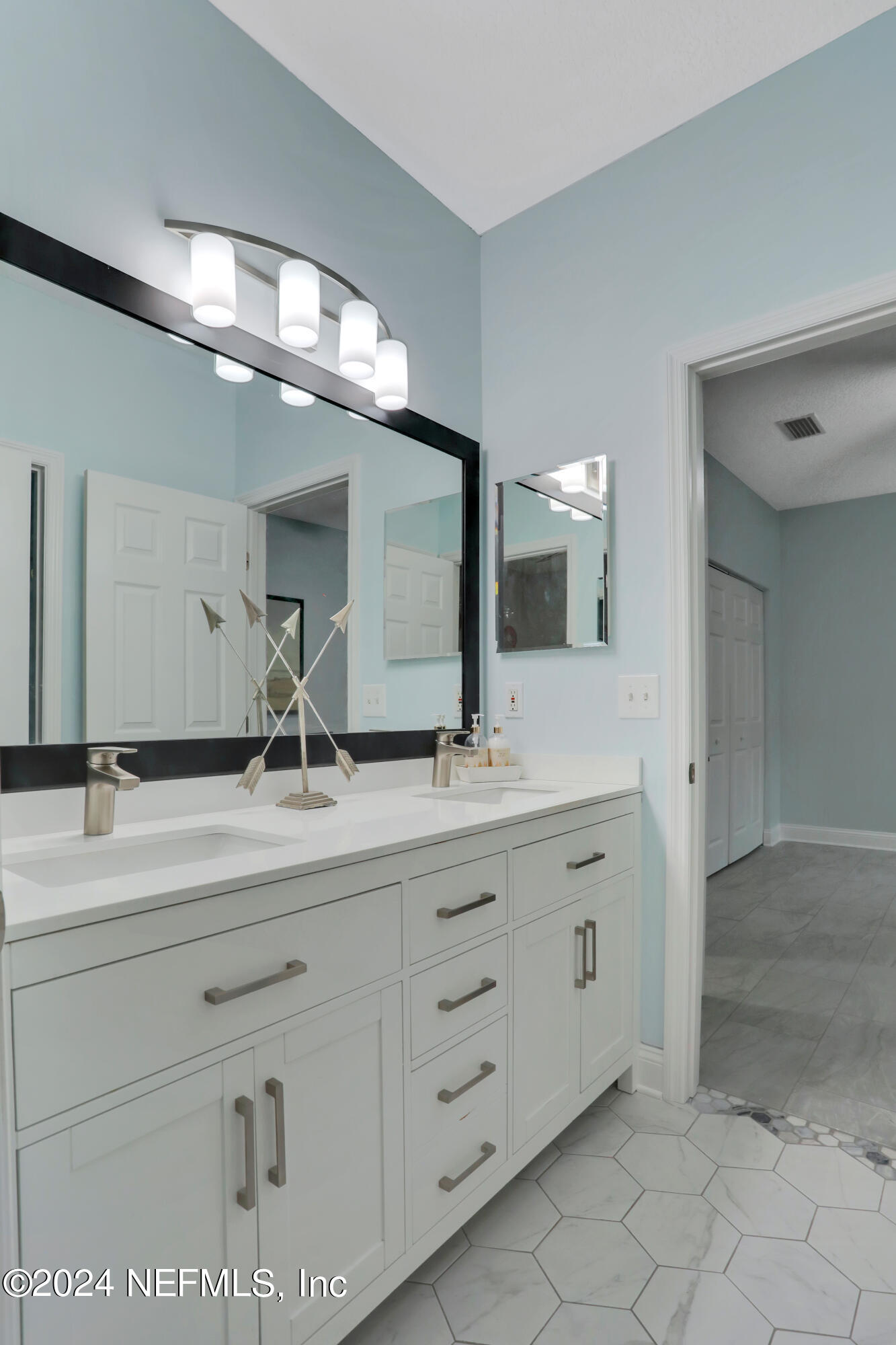 346 Porta Rosa Circle St. Augustine, FL 32092 - Photo 32 of 53 a bathroom with a double vanity sink and a mirror