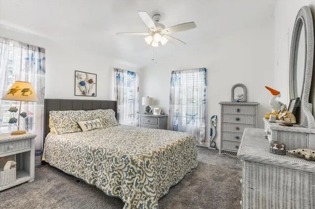 a bedroom with a bed and ceiling fan