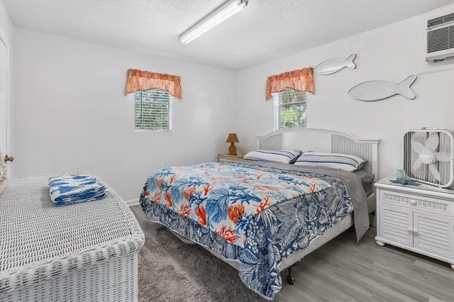 a bedroom with a bed and painting on the wall