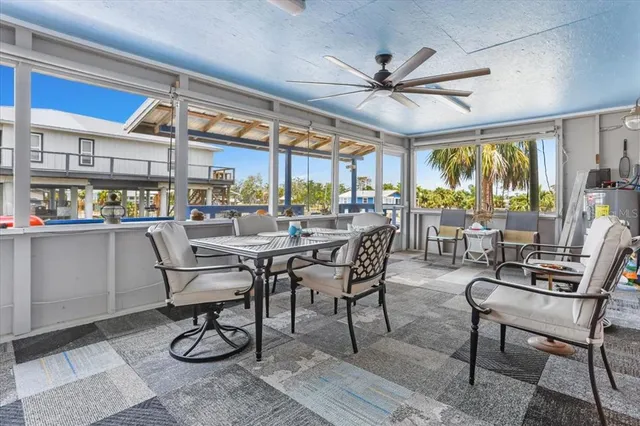 a dining room with furniture a rug and a floor to ceiling window