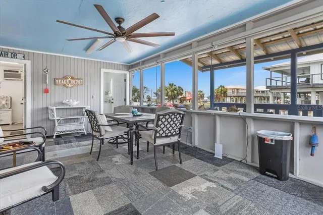 a dining hall with stainless steel appliances kitchen island granite countertop furniture and a large window