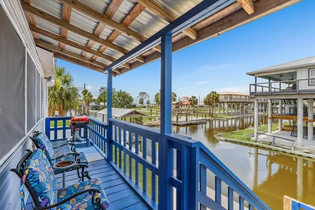 a view of a balcony with lake view and a wooden floor