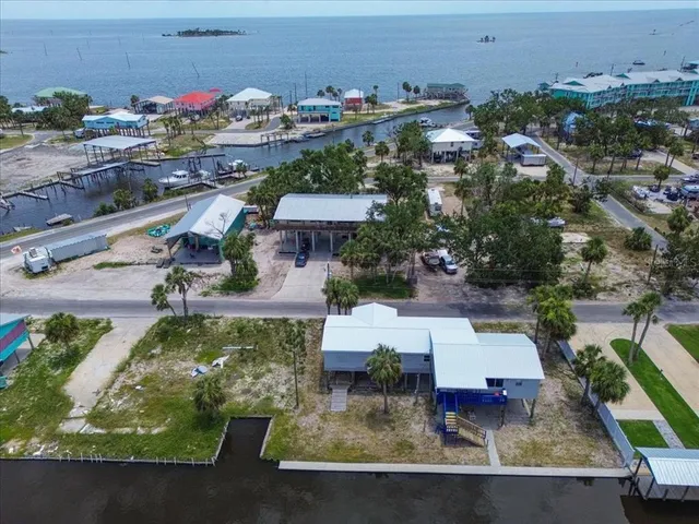 an aerial view of a house with a yard basket ball court and outdoor seating