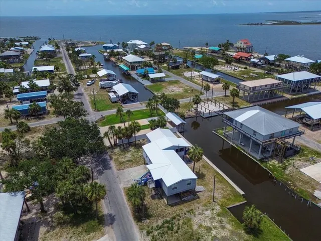 an aerial view of multiple houses with yard