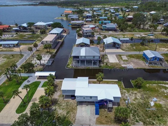 an aerial view of a houses with yard