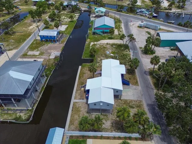 an aerial view of a house with a yard