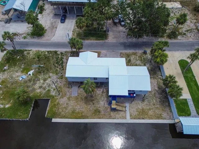an aerial view of a house with yard swimming pool and outdoor seating