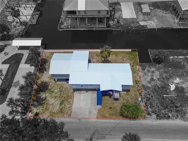 an aerial view of a house with a yard