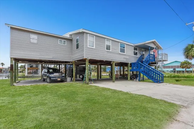 a view of a house with a yard patio and sitting area