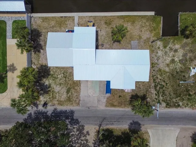 an aerial view of a house with a yard