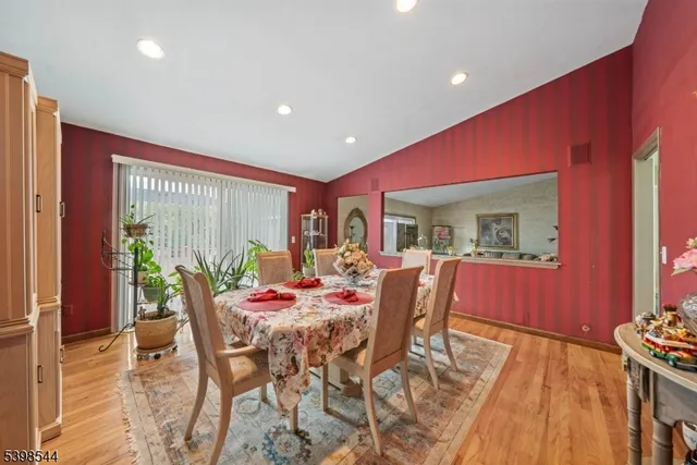 a dining room with furniture and a floor to ceiling window