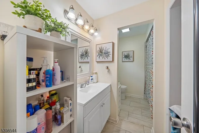 a spacious bathroom with a sink a mirror and shower