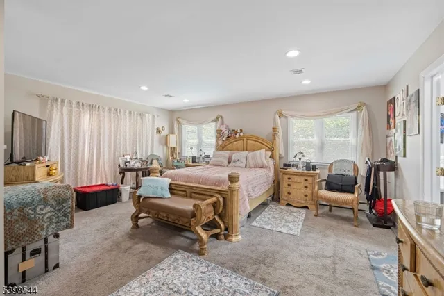 a bedroom with furniture and a flat screen tv