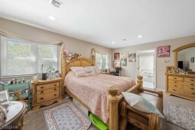 a bedroom with a bed and wooden furniture