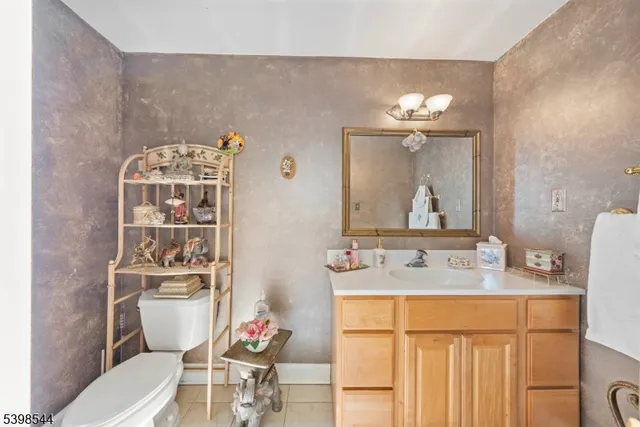 a bathroom with a sink mirror and toilet