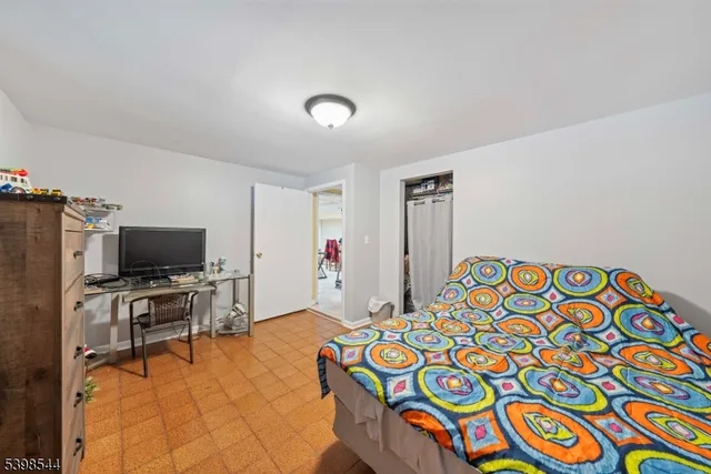 a bedroom with a bed and flat screen tv