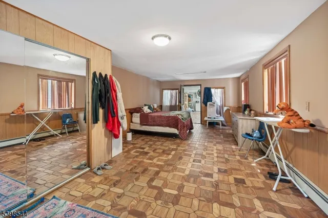 a living room with furniture a flat screen tv and a large window