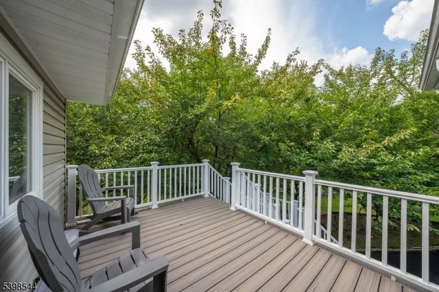 a view of backyard with deck and outdoor seating
