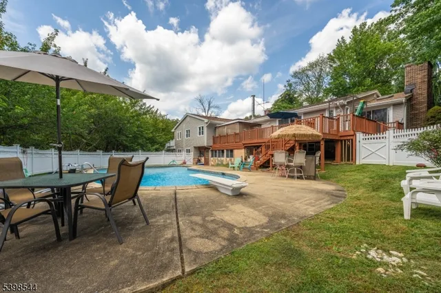 a patio with a table and chairs under an umbrella