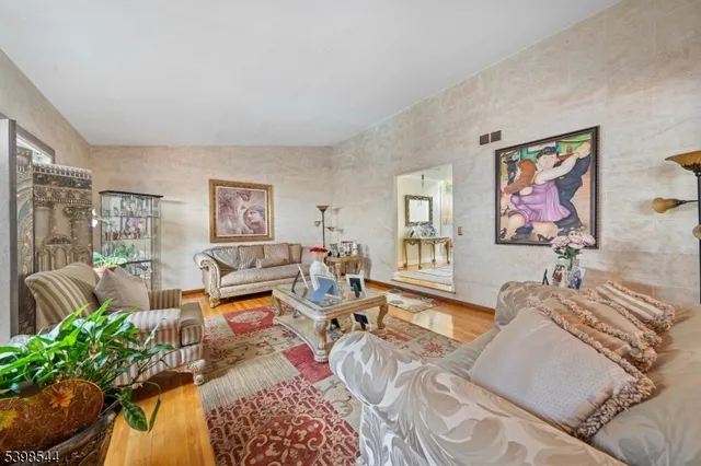 a living room with furniture a couch and a potted plant