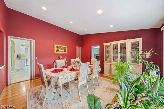 a dining room with furniture and a potted plant