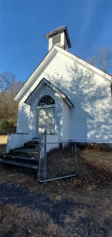 a view of backyard with wooden fence