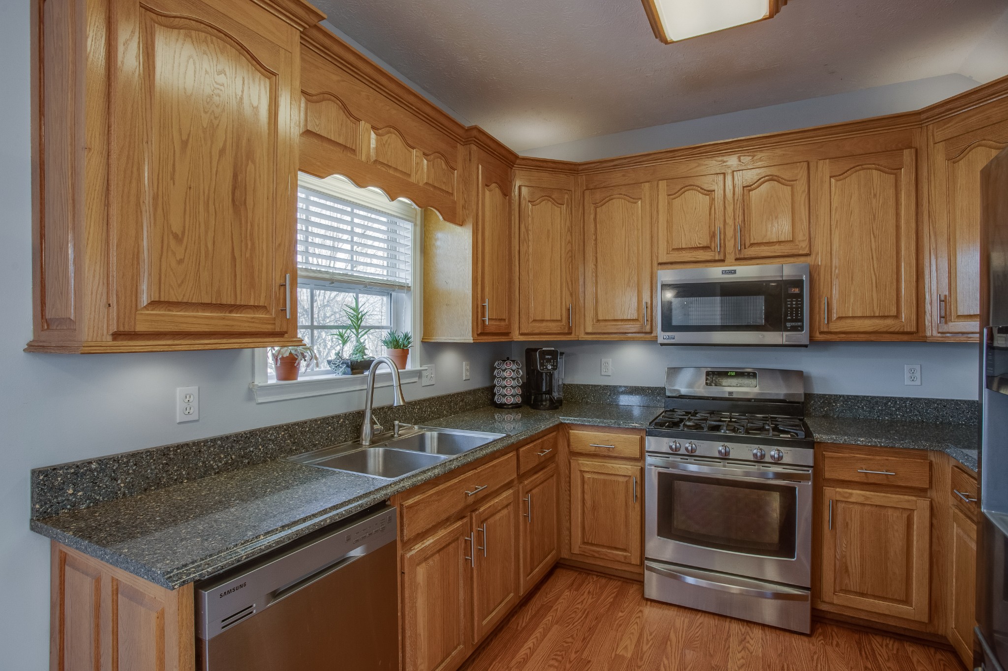 2918 Buckner Lane Spring Hill, TN 37174 - Photo 16 of 54 a kitchen with stainless steel appliances granite countertop a sink stove and microwave