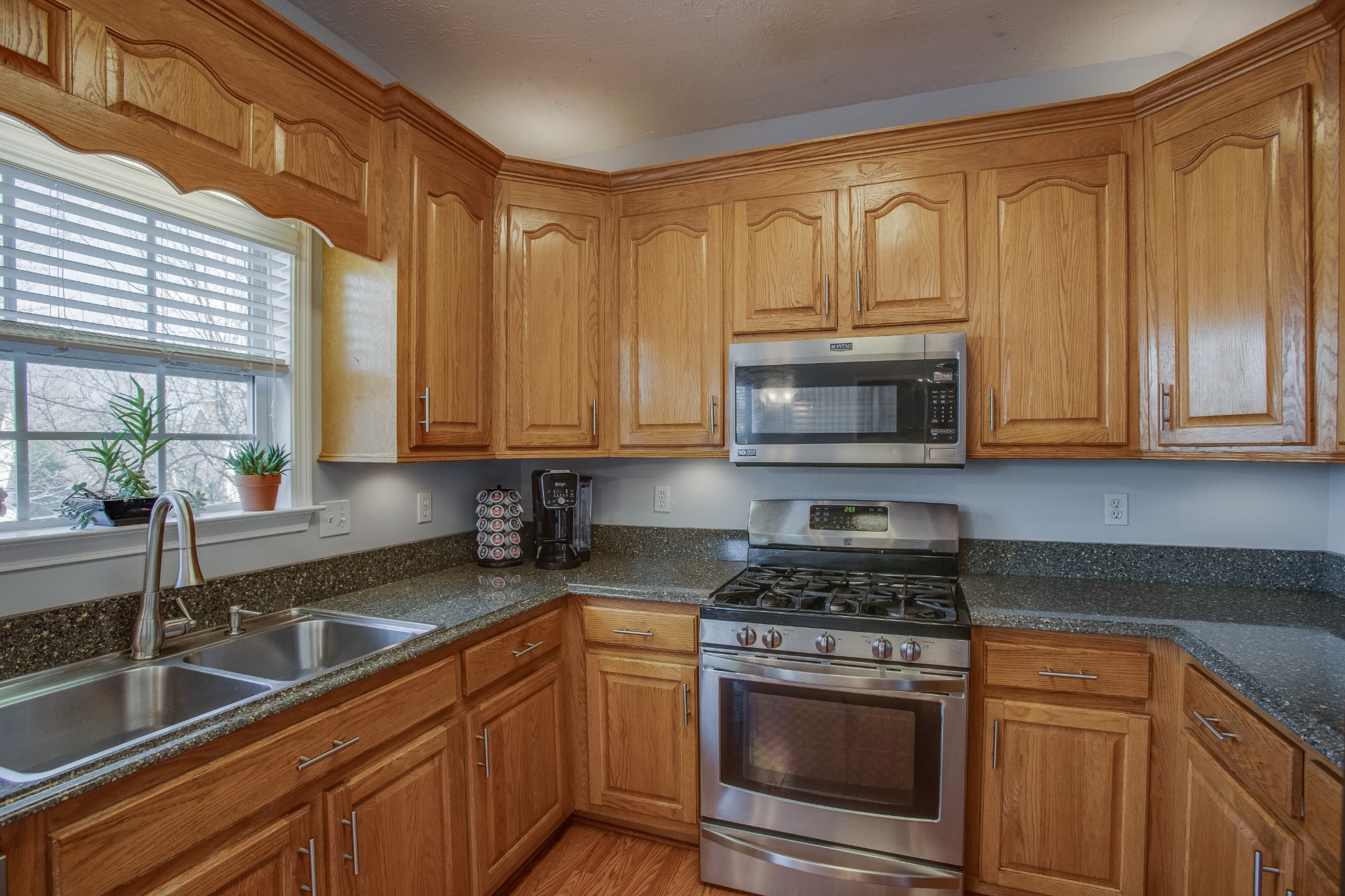 2918 Buckner Lane Spring Hill, TN 37174 - Photo 18 of 54 a kitchen with stainless steel appliances granite countertop white cabinets granite counter tops and a window