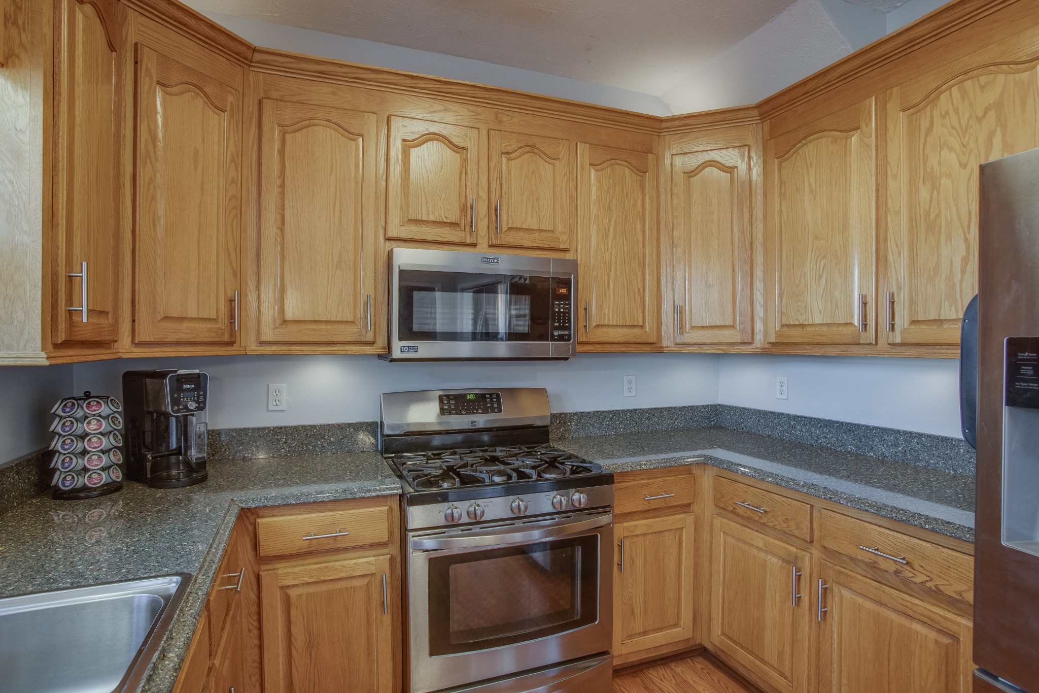 2918 Buckner Lane Spring Hill, TN 37174 - Photo 19 of 54 a kitchen with stainless steel appliances granite countertop white cabinets a sink and dishwasher