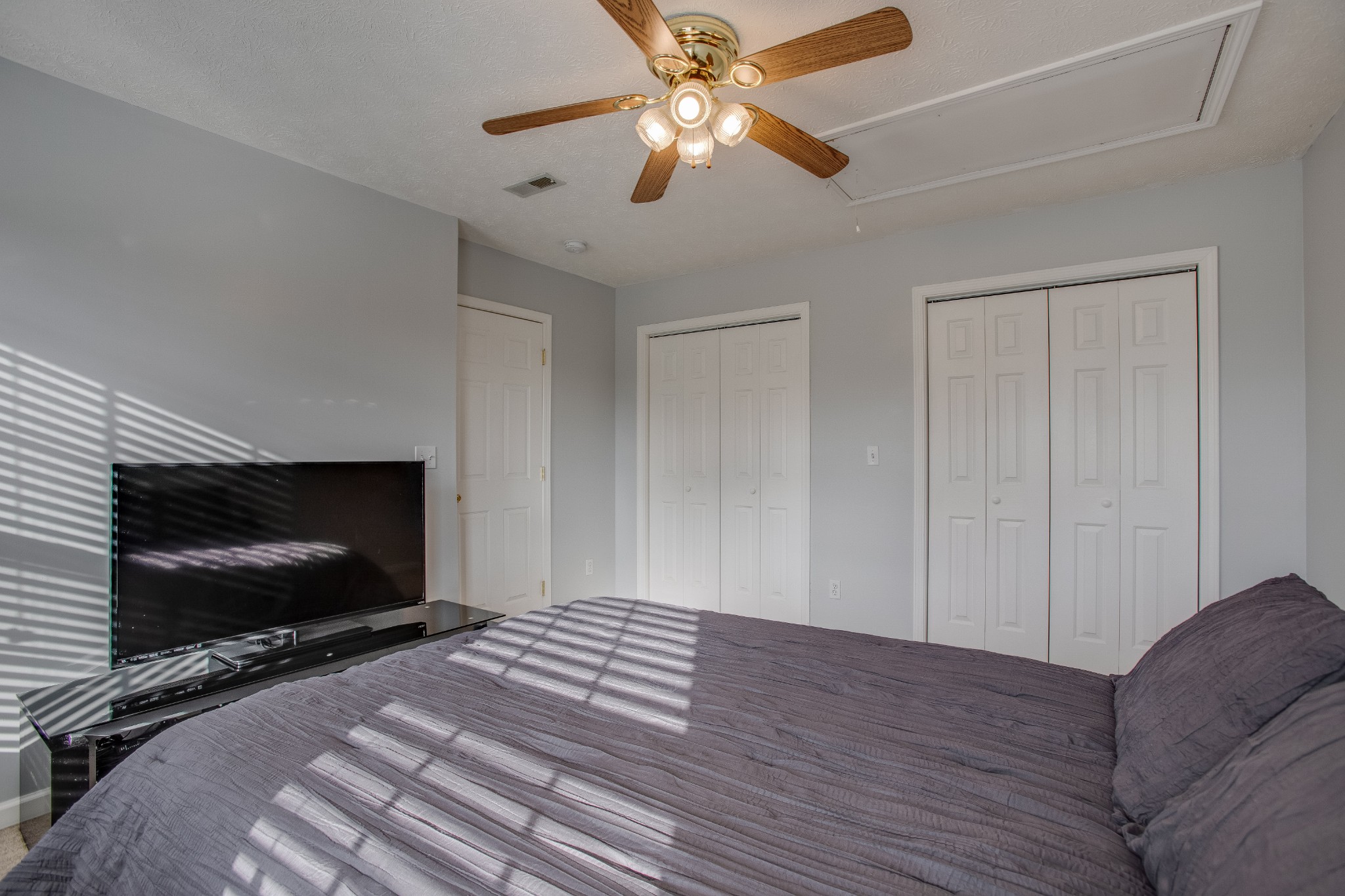 2918 Buckner Lane Spring Hill, TN 37174 - Photo 38 of 54 a bedroom with a bed and a flat screen tv