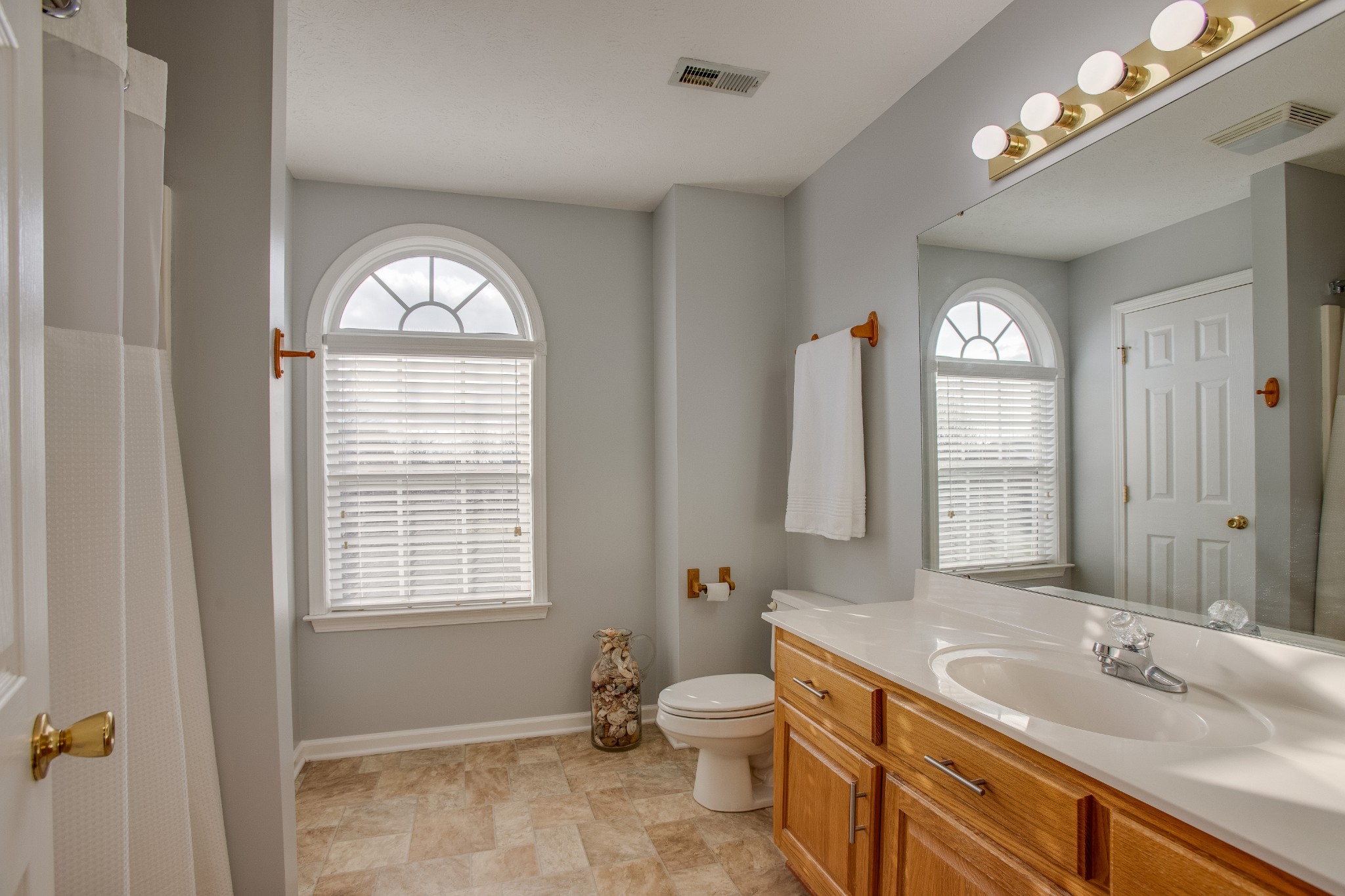 2918 Buckner Lane Spring Hill, TN 37174 - Photo 39 of 54 a spacious bathroom with a toilet sink and mirror
