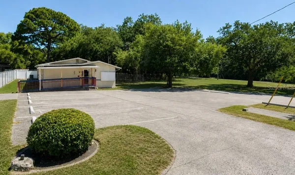 a view of backyard with swimming pool and seating space