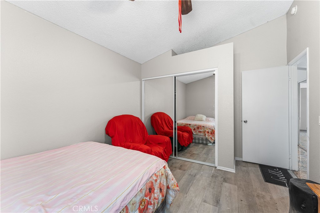 3542 East Ave R 10 Palmdale, CA 93550 - Photo 23 of 35 a bedroom with a bed and a window