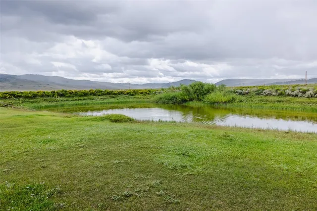 a view of a lake with houses in the back